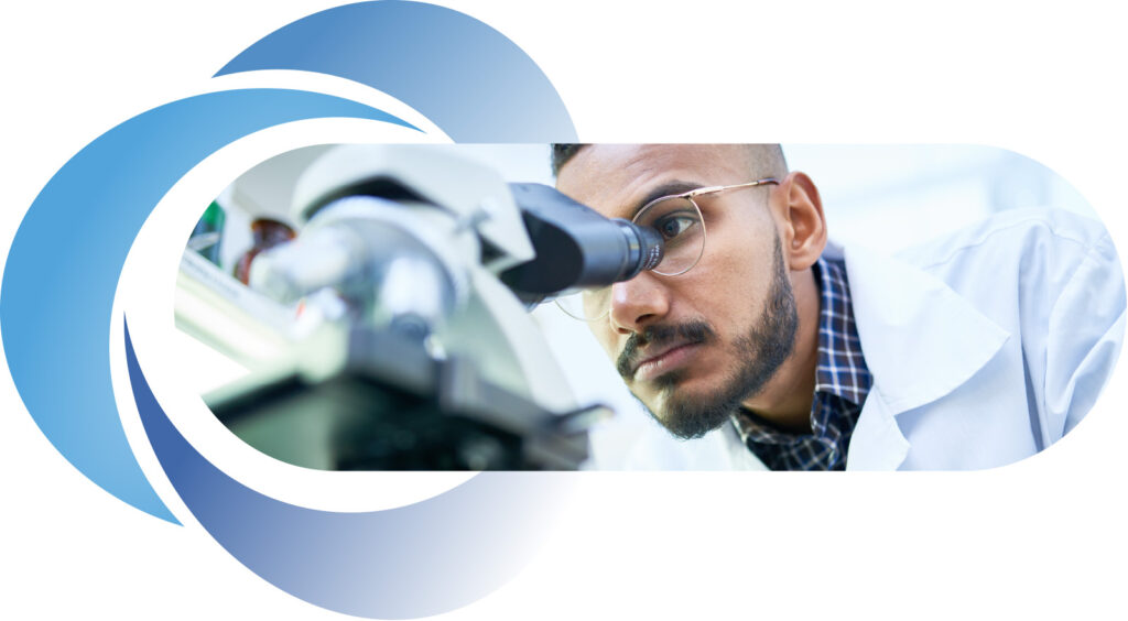 Man peering through microscope